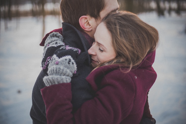 Couple embracing in the snow, couples counseling in Denver